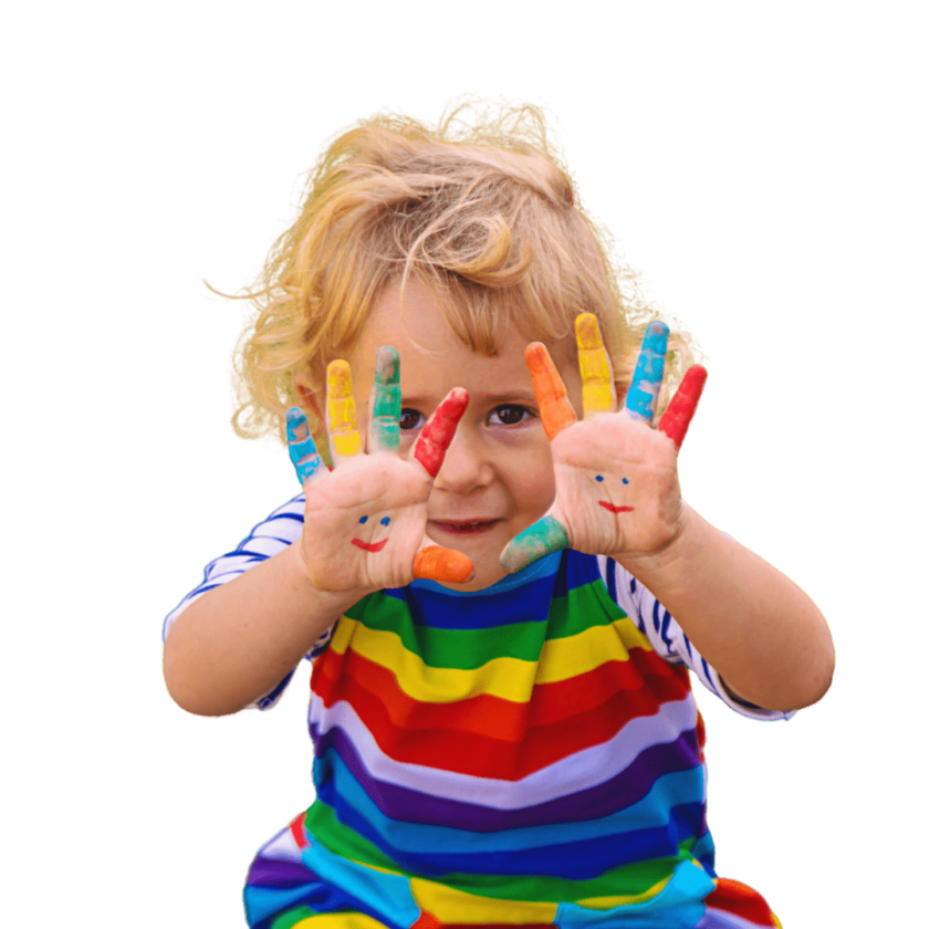 Young child in a rainbow-striped shirt showing painted hands with smiley faces, with fingers covered in different colors.