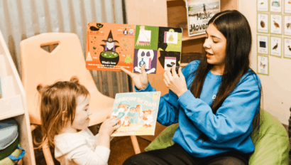Woman reading to toddler.